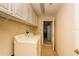 Well-equipped laundry room with a washer, dryer, utility sink, and storage cabinets at 1038 Emerald Dunes Dr, Sun City Center, FL 33573