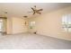 Spacious living room with neutral walls, large windows, and an elegant chandelier at 1038 Emerald Dunes Dr, Sun City Center, FL 33573