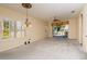 Bright living room features plush carpet, large windows and sliding glass doors to the lanai at 1038 Emerald Dunes Dr, Sun City Center, FL 33573