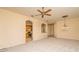 Open living room with carpeted floors and view to the kitchen through an arched doorway at 1038 Emerald Dunes Dr, Sun City Center, FL 33573