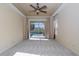 A bright main bedroom featuring sliding glass doors leading to a screened-in pool at 1038 Emerald Dunes Dr, Sun City Center, FL 33573