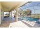 Spacious covered patio with brick pavers, ceiling fan, and screened-in pool, ideal for outdoor living at 1038 Emerald Dunes Dr, Sun City Center, FL 33573