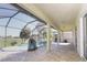 Lovely, screened-in patio with brick pavers, ceiling fan and a view of the pool at 1038 Emerald Dunes Dr, Sun City Center, FL 33573