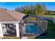 Aerial view of a home with a screened-in pool and patio, showcasing outdoor living at 1044 Manzanar Pl, Wesley Chapel, FL 33543