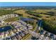 Wide aerial view of a planned community featuring lakes, nature trails and beautiful landscaping at 1044 Manzanar Pl, Wesley Chapel, FL 33543