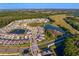 Expansive aerial view of planned community with multiple lakes, fountains and mature landscaping at 1044 Manzanar Pl, Wesley Chapel, FL 33543