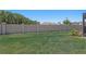 Spacious backyard enclosed by a decorative wall and with a glimpse of the screened in pool at 1044 Manzanar Pl, Wesley Chapel, FL 33543
