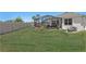 Large backyard features a well-maintained lawn and a screened in pool area for outdoor enjoyment at 1044 Manzanar Pl, Wesley Chapel, FL 33543