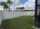 Spacious backyard with a vinyl fence and lush green grass perfect for outdoor activities at 1044 Manzanar Pl, Wesley Chapel, FL 33543