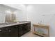 Modern bathroom featuring double granite vanity, framed mirror, and glass enclosed shower at 1044 Manzanar Pl, Wesley Chapel, FL 33543