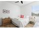 Bright bedroom features a ceiling fan, window with blinds, and light wood floors at 1044 Manzanar Pl, Wesley Chapel, FL 33543