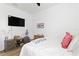 Cozy bedroom with TV, accent decorations and a side table at 1044 Manzanar Pl, Wesley Chapel, FL 33543