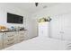 This bright bedroom includes dresser, a TV and closet at 1044 Manzanar Pl, Wesley Chapel, FL 33543