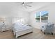 Bright bedroom with a full bed, side tables, and a comfortable chair bathed in natural light at 1044 Manzanar Pl, Wesley Chapel, FL 33543
