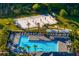 Aerial view of a community pool, basketball court and sun loungers in lushly landscaped neighborhood at 1044 Manzanar Pl, Wesley Chapel, FL 33543