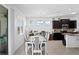 Dining room with a table and chairs, with views of kitchen and office, bathed in natural light at 1044 Manzanar Pl, Wesley Chapel, FL 33543