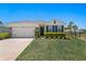 Lovely single Gathering home boasts lush landscaping and an attached garage in a serene neighborhood at 1044 Manzanar Pl, Wesley Chapel, FL 33543