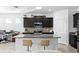 Modern kitchen with a large island and stylish bar stool seating at 1044 Manzanar Pl, Wesley Chapel, FL 33543