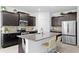 Stunning kitchen with granite countertops, stainless steel appliances, and a breakfast bar with seating at 1044 Manzanar Pl, Wesley Chapel, FL 33543