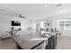 Bright and airy kitchen showcasing a spacious island that connects to the living and dining areas at 1044 Manzanar Pl, Wesley Chapel, FL 33543
