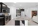 Modern kitchen with stainless steel appliances, granite countertops, and an expansive island for meal prep at 1044 Manzanar Pl, Wesley Chapel, FL 33543