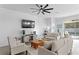 Cozy living room featuring comfortable seating and direct access to the outdoor pool at 1044 Manzanar Pl, Wesley Chapel, FL 33543