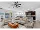 Open-concept living room that connects to the kitchen, dining area, and outdoor pool at 1044 Manzanar Pl, Wesley Chapel, FL 33543