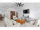 Bright living room with stylish furnishings and a view to the entryway at 1044 Manzanar Pl, Wesley Chapel, FL 33543
