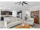 Spacious living room open to a kitchen with dark cabinets and a large island at 1044 Manzanar Pl, Wesley Chapel, FL 33543