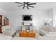 Bright living room with stylish furnishings and a large TV at 1044 Manzanar Pl, Wesley Chapel, FL 33543