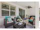 Comfortable seating arrangement on the patio includes cushioned chairs, colorful pillows, and an area rug at 1044 Manzanar Pl, Wesley Chapel, FL 33543