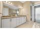 Bathroom featuring a double sink vanity with granite counters and a glass enclosed tiled shower at 1110 Overlook Ct, Bradenton, FL 34208