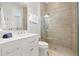 Bright bathroom featuring a walk-in shower and a white vanity with undermount sink and quartz countertop at 1110 Overlook Ct, Bradenton, FL 34208