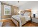 Bright bedroom featuring hardwood floors, stylish decor, and a plush upholstered headboard at 1110 Overlook Ct, Bradenton, FL 34208