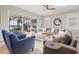 Comfortable living room with ample seating, hardwood floors and a view of the outdoor entertainment area at 1110 Overlook Ct, Bradenton, FL 34208