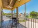 Screened balcony with seating and ceiling fan, overlooking street and landscaping at 1140 81St S St, St Petersburg, FL 33707