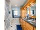 Well-lit bathroom featuring a large vanity with double sinks, granite countertops and tile flooring at 1140 81St S St, St Petersburg, FL 33707
