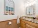 Charming powder room with decorative mirror and a whimsical mural, adding a unique touch at 1140 81St S St, St Petersburg, FL 33707
