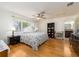 Bright bedroom featuring hardwood floors, a ceiling fan, and a window view at 1140 81St S St, St Petersburg, FL 33707