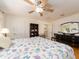 Comfortable bedroom with ceiling fan, dark dresser, and large bed, creating a relaxing atmosphere at 1140 81St S St, St Petersburg, FL 33707