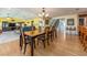 Open-concept dining room with hardwood floors and a chandelier, flowing into the living room and kitchen at 1140 81St S St, St Petersburg, FL 33707