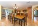 Bright dining room featuring hardwood floors, an open layout, and views of the staircase and kitchen at 1140 81St S St, St Petersburg, FL 33707