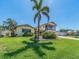 Beautiful single-Gathering home boasting a well-maintained lawn, mature landscaping, and a two-car garage at 1140 81St S St, St Petersburg, FL 33707