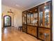 Elegant foyer showcasing hardwood floors, an arched doorway, and a large built-in cabinet at 1140 81St S St, St Petersburg, FL 33707