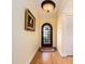 Bright foyer featuring hardwood floors, an arched doorway, a decorative rug, and a closet at 1140 81St S St, St Petersburg, FL 33707