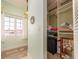 Hallway with view to closet, window, and pendant lighting, with a wall mirror at 1140 81St S St, St Petersburg, FL 33707