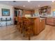 Spacious kitchen featuring wood cabinets, granite countertops, stainless steel appliances, and an island with bar seating at 1140 81St S St, St Petersburg, FL 33707