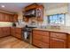 Well-equipped kitchen showcasing wood cabinetry, stainless steel appliances, granite countertops, and ample natural light at 1140 81St S St, St Petersburg, FL 33707