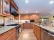 A well-designed kitchen featuring wood cabinets, granite countertops, stainless steel appliances, and an open layout at 1140 81St S St, St Petersburg, FL 33707