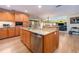Open kitchen area with granite countertops, stainless steel appliances, wood cabinetry, and a view of the living space at 1140 81St S St, St Petersburg, FL 33707